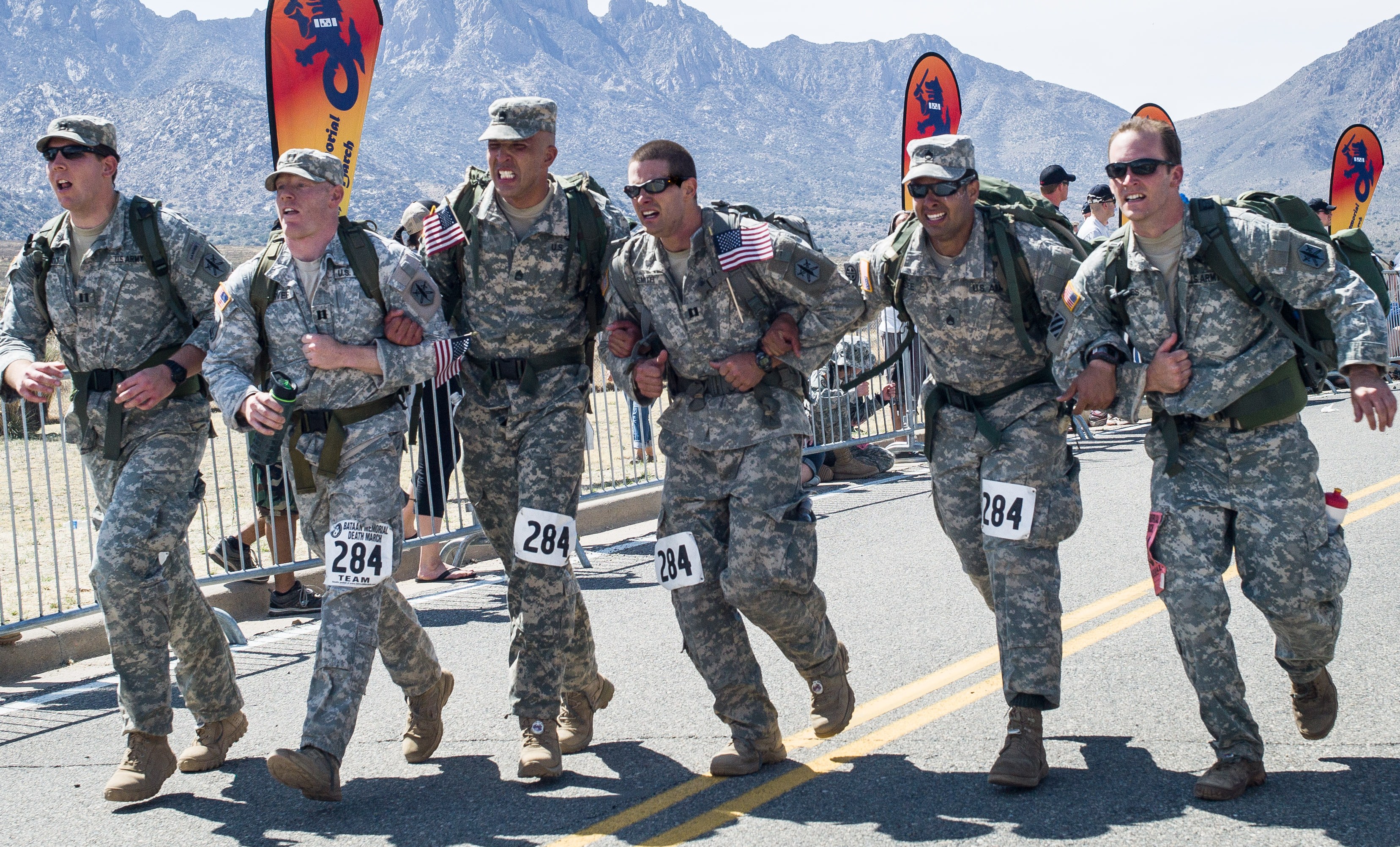 20120327-A-RE761-010: Members of the 81st Civil Affairs Battalion ‘Tribal Endurance’ Bataan Death March Team prepare to cross the finish line of the 23rd Annual Bataan Memorial Death March held March 25 at the White Sands Missile Range in New Mexico. The 26.2-mile march is held each year to commemorate the forcible transfer of more than 70,000 Filipino and American civilians and Soldiers over an 80-mile distance by the Imperial Japanese Army during WWII. This year’s event was the largest ever – with more than 7,000 participants. The team officially placed third overall in the military male heavy team division with each member carrying a rucksack weighing at least 35lbs. The team is also officially the highest placing male heavy division team based out of Fort Hood. From left to right, the team members are: Capt. Alex Perotti, Capt. Brian Garver, Sgt. 1st Class Gerardo Lora, Capt. Aaron K. Smith, Staff Sgt. Jose M. Ledee, and Capt. Michael Jones. (Photo by Staff Sgt. Michael J. Dator, 85th Civil Affairs Brigade Public Affairs) 