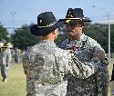 Command Sgt. Maj. Isaia Vimoto, former command sergeant major of the 1st Cavalry Division, receives the Legion of Merit Medal from Maj. Gen. Anthony Ierardi, commanding general of the Cav., during a patch ceremony to recognize Vimoto and the changing of the division's deputy commanding general of support, July 5 on Cooper Field.